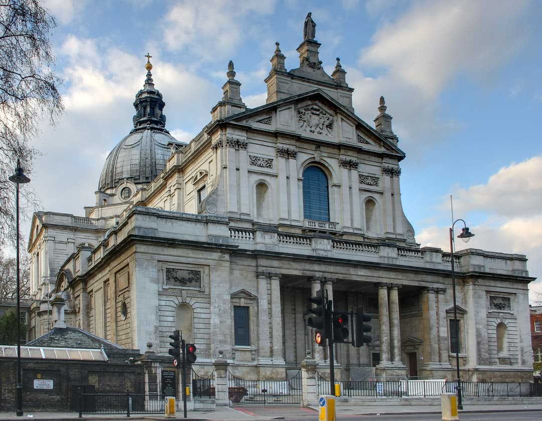 Angled exterior view of the Brompton Oratory facade and dome, London.