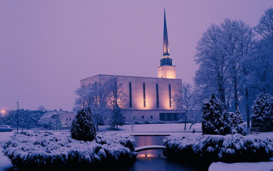 The London England Temple surrounded by lush greenery.