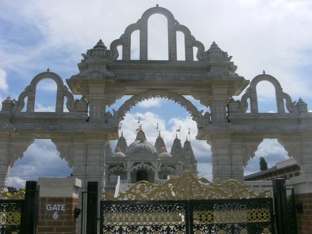 View of the main Mandir through Gate 6 and the ornate carved stone archway.