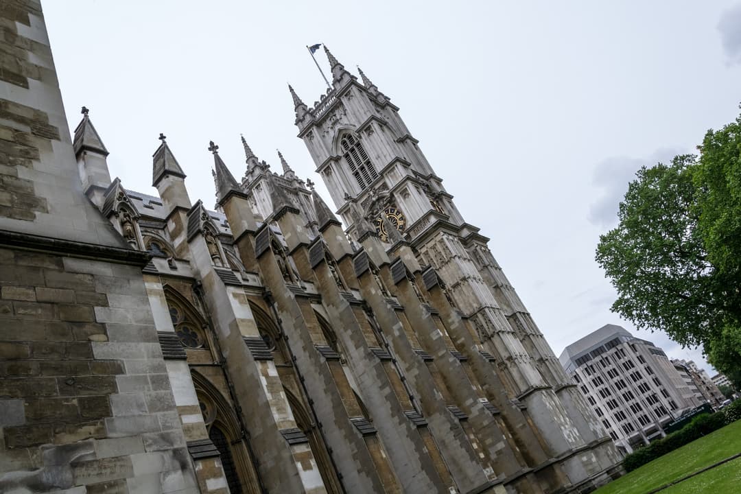 Low-angle view of the flying buttresses and tower of Westminster Abbey.