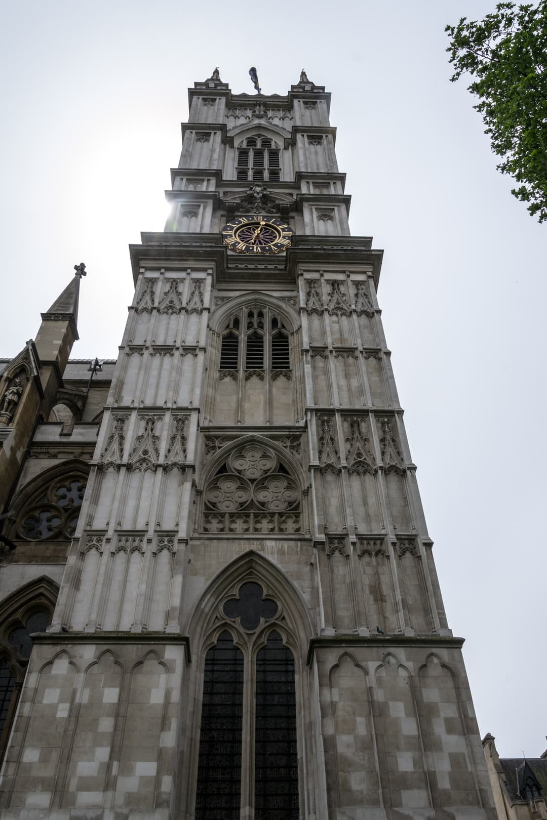 Low-angle view looking up at the west clock tower of Westminster Abbey.