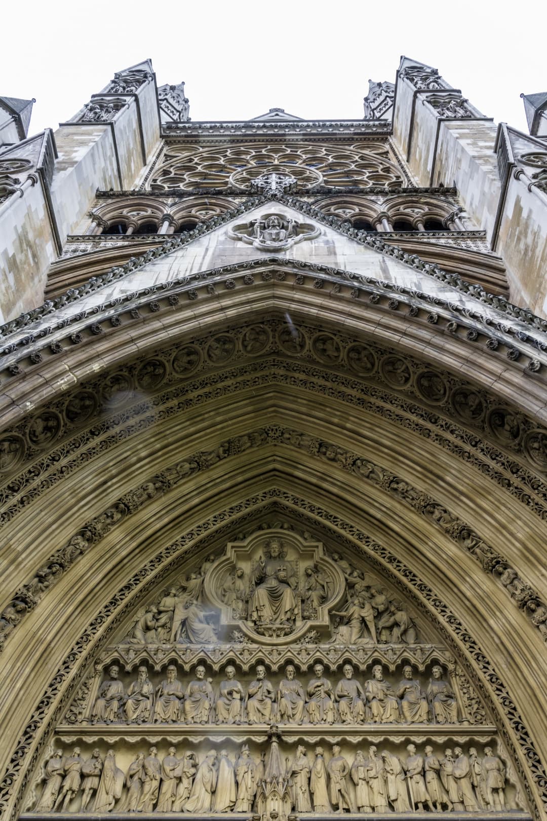 Low-angle view of the carved Gothic entrance portal and facade.