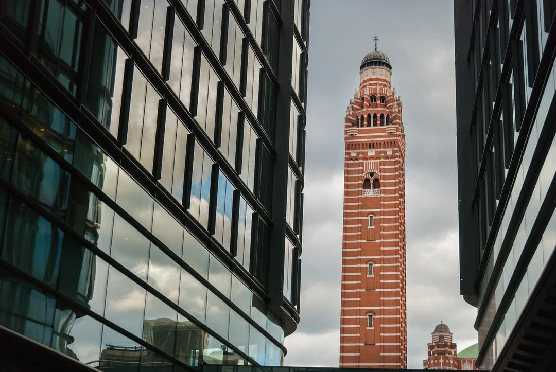 Westminster Cathedral's campanile framed by modern glass buildings.