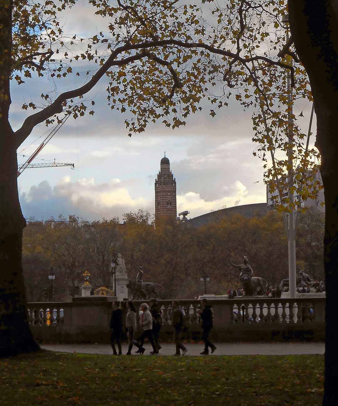 Distant view of Westminster Cathedral's campanile framed by autumn trees.