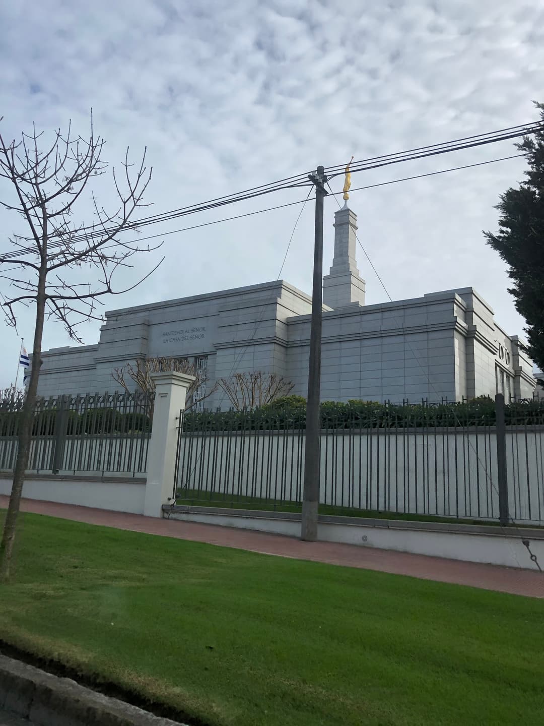 Montevideo Uruguay Temple exterior, spire with Angel Moroni, cloudy sky.