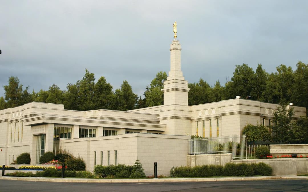 The Anchorage Alaska Temple surrounded by trees.