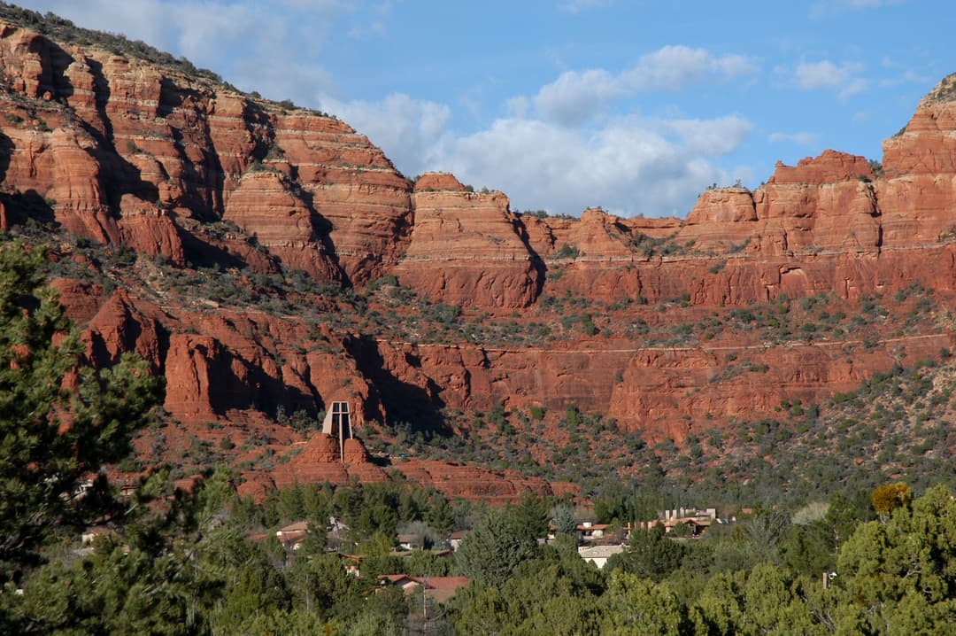 Distant view of the Chapel of the Holy Cross built into Sedona's red rocks.
