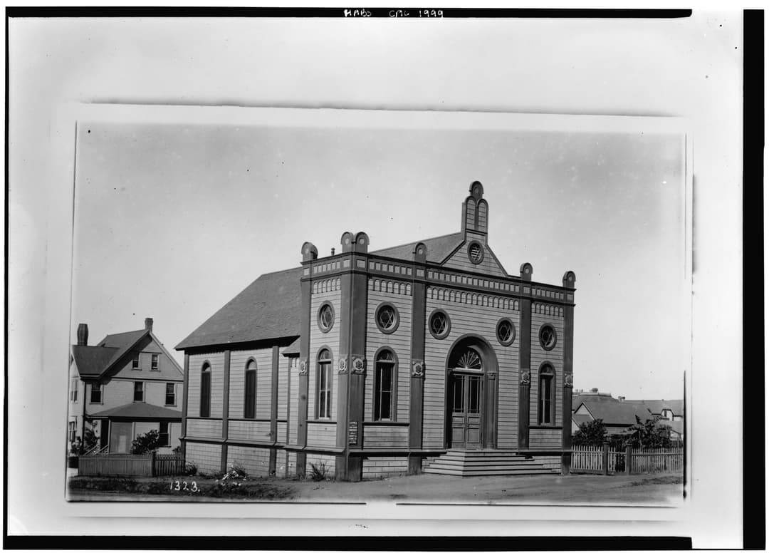 Historic exterior view of the front entrance and side elevation