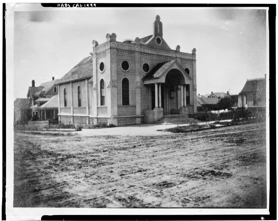 Historic exterior three-quarter view of the front entrance and facade