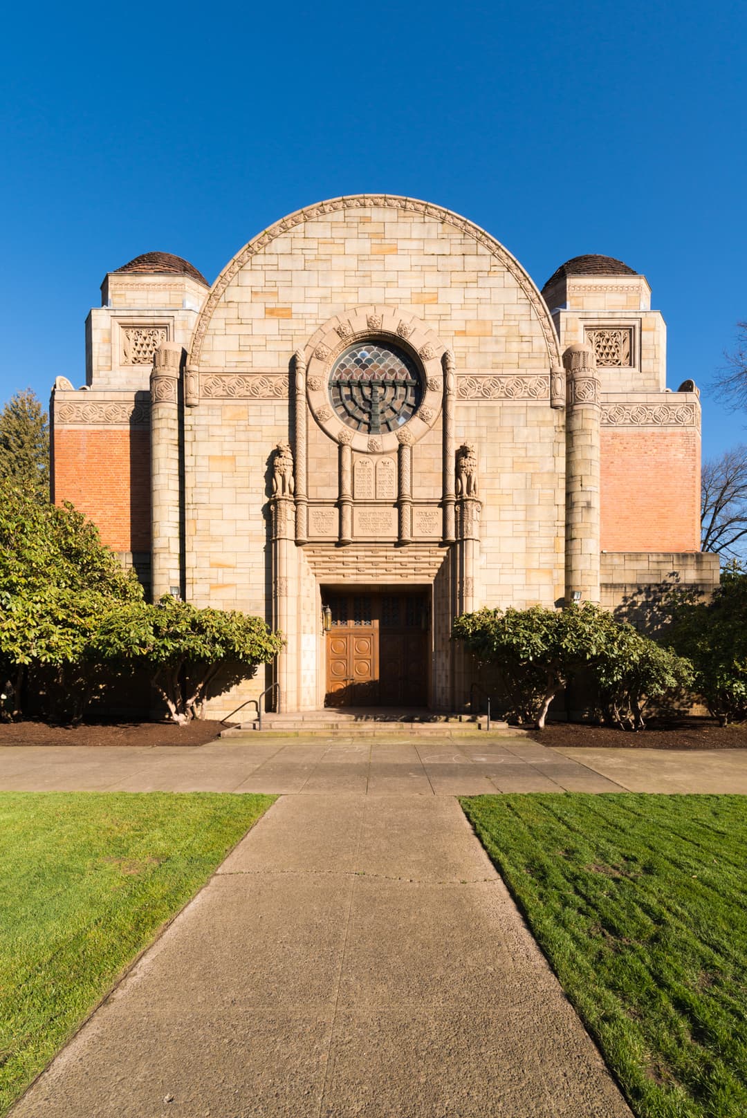 Front entrance and stone facade featuring a round menorah window