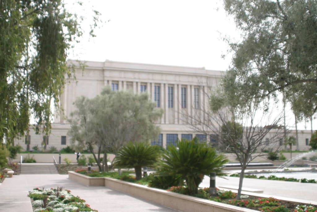 Temple exterior, landscaped grounds, and reflecting pool.