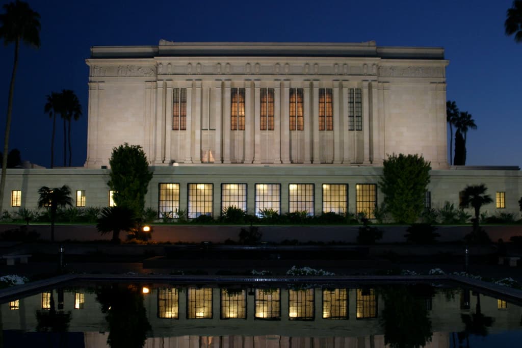 Mesa Arizona Temple at night, reflected in the garden's water feature.