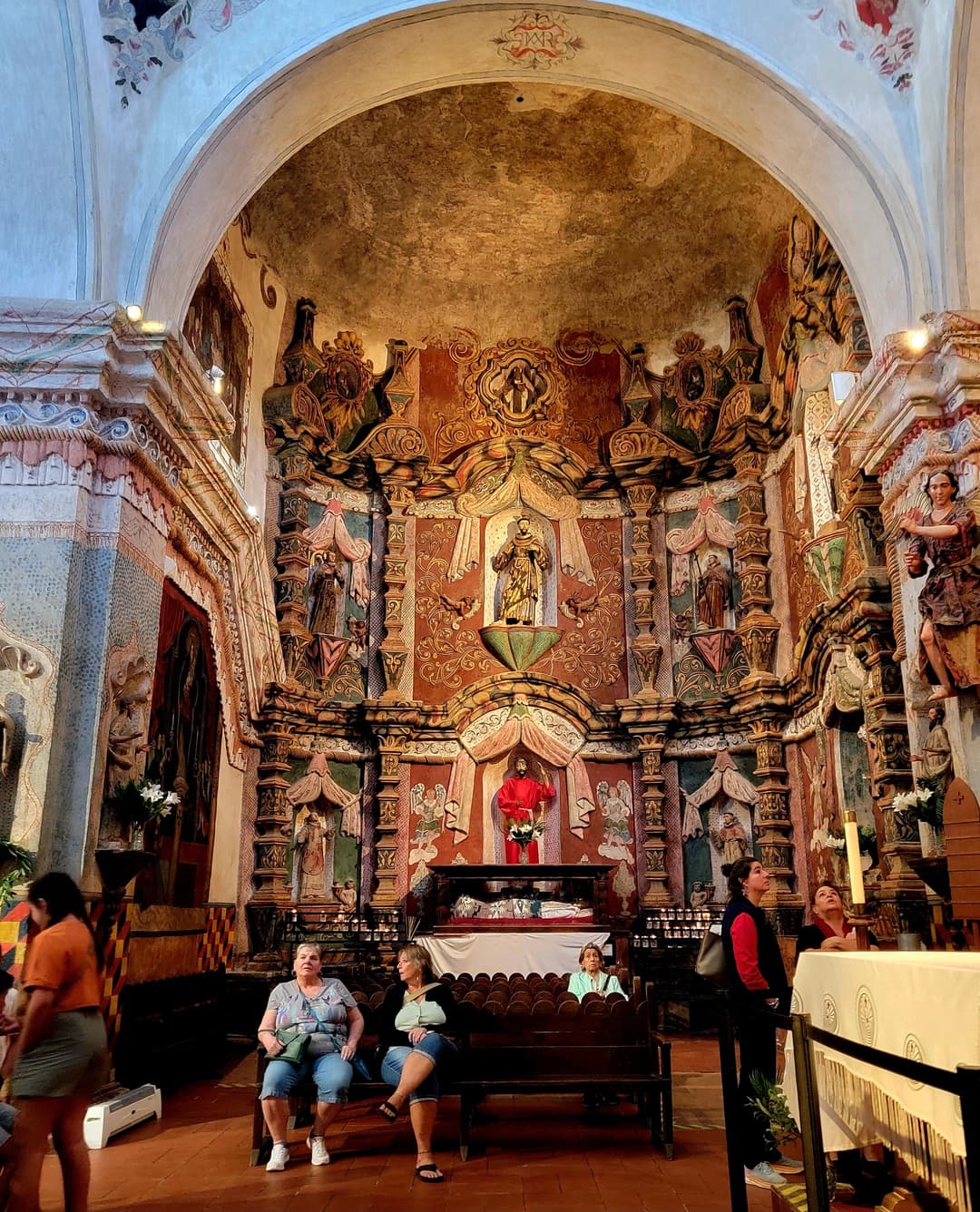 Interior view of the ornate retablo mayor at Mission San Xavier del Bac.