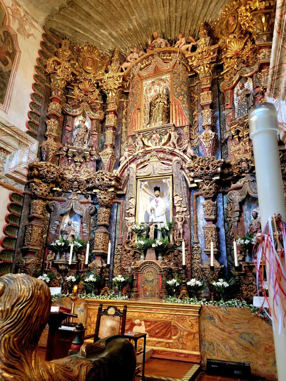 Ornate gilded retablo at the main altar inside Mission San Xavier del Bac.
