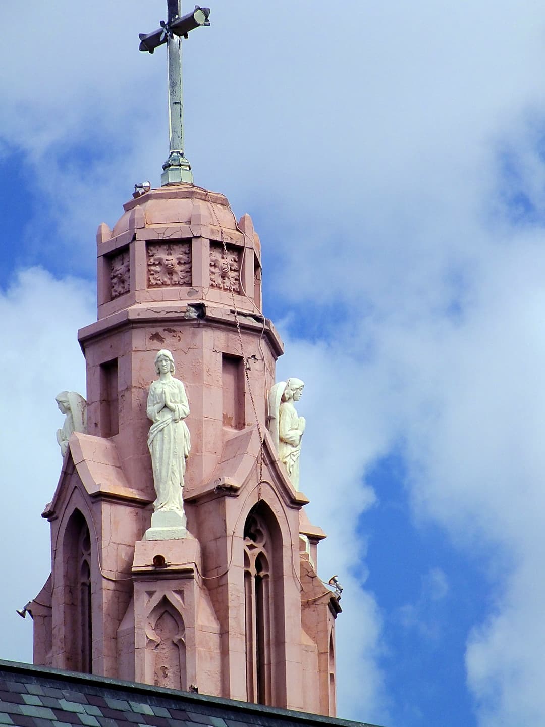 Exterior detail of the spire with angel statues and cross