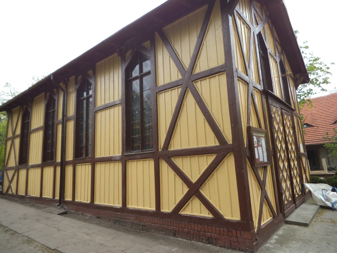 Exterior view of the timber-framed chapel with pointed-arch windows.