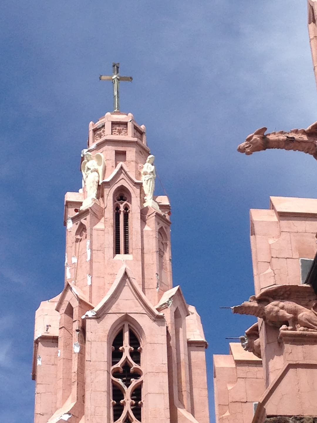 Close-up of the Gothic spire, angel figures, and gargoyles