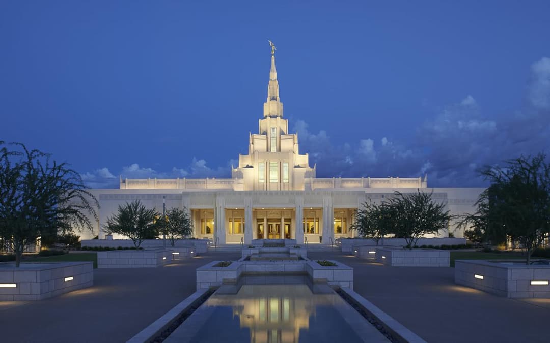 Front exterior of the Phoenix Arizona Temple with reflecting pool at twilight.