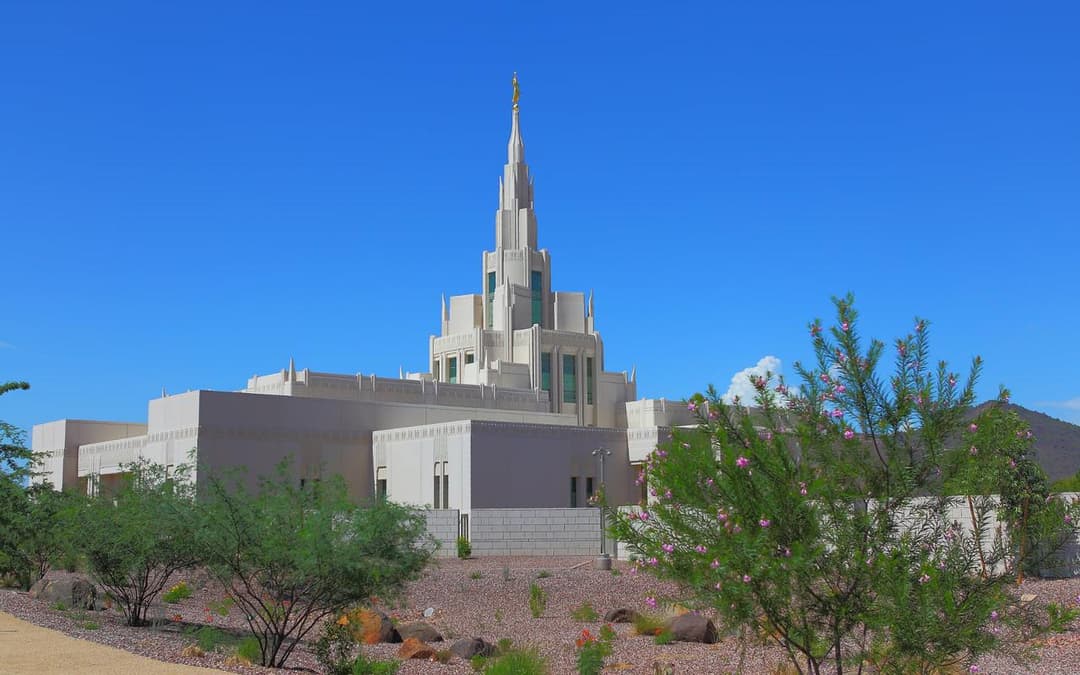Exterior view of the Phoenix Arizona Temple spire and desert landscaping.