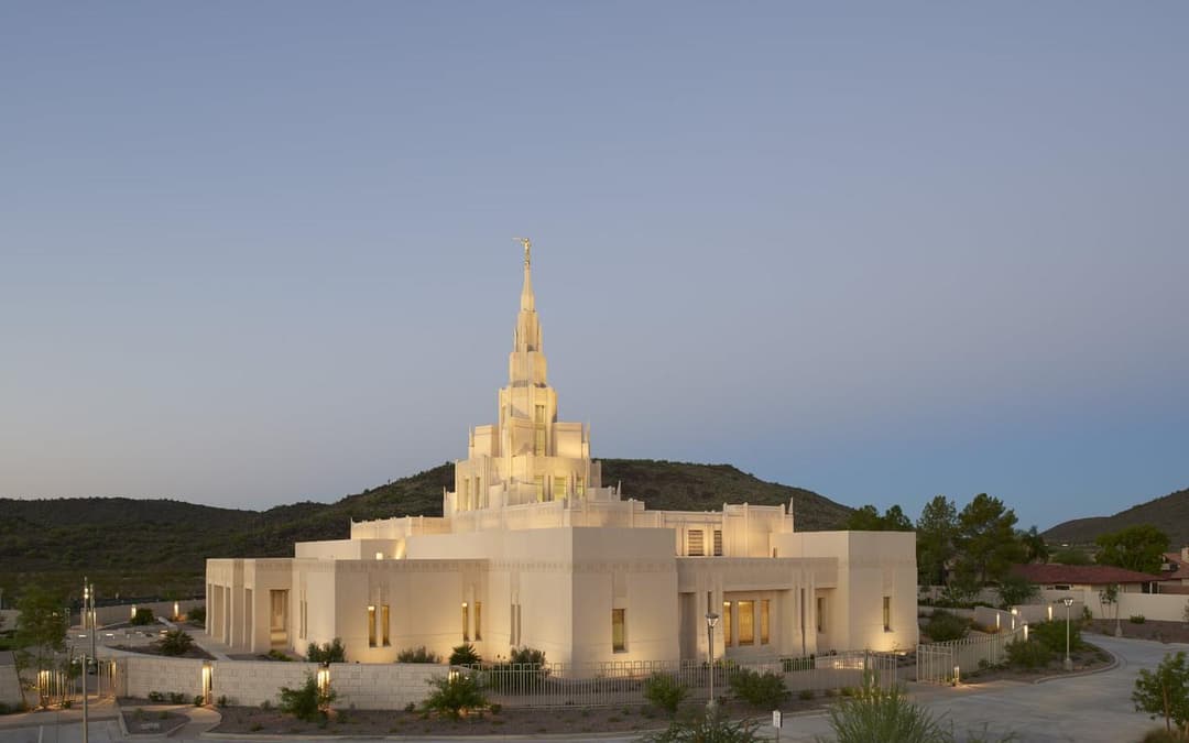 Exterior view of the Phoenix Arizona Temple illuminated at dusk.