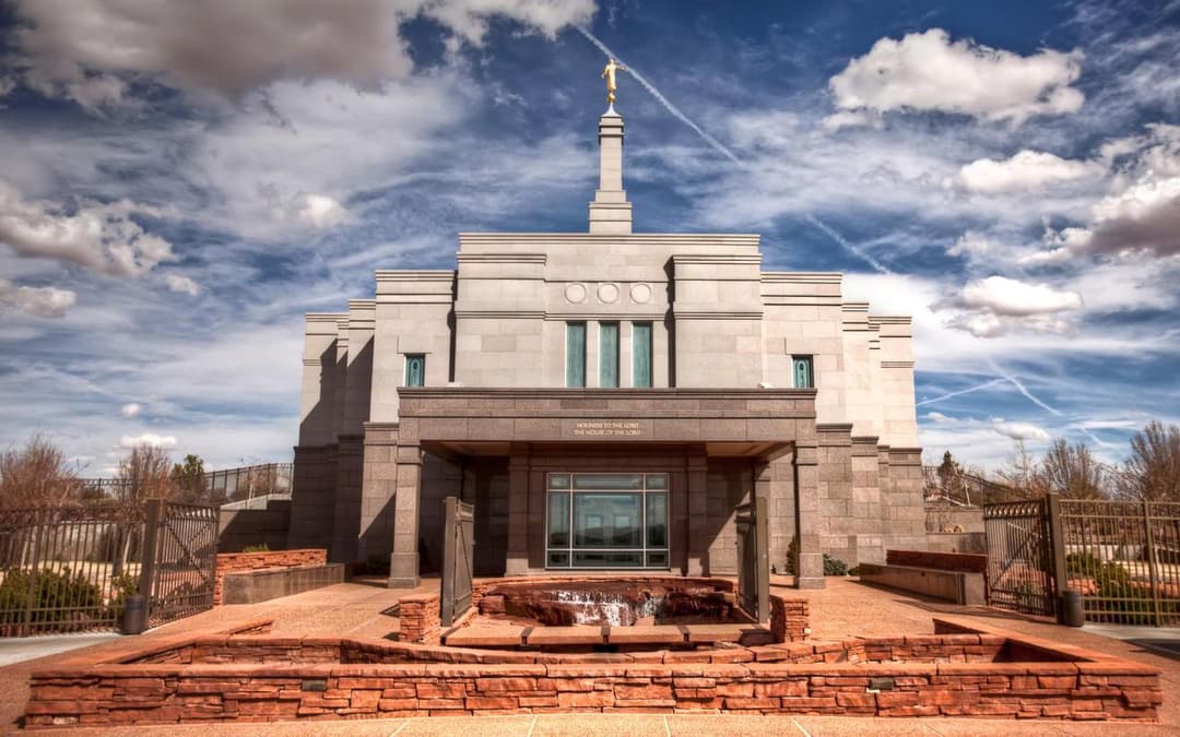 Front view of the Snowflake Arizona Temple entrance and red rock fountain.