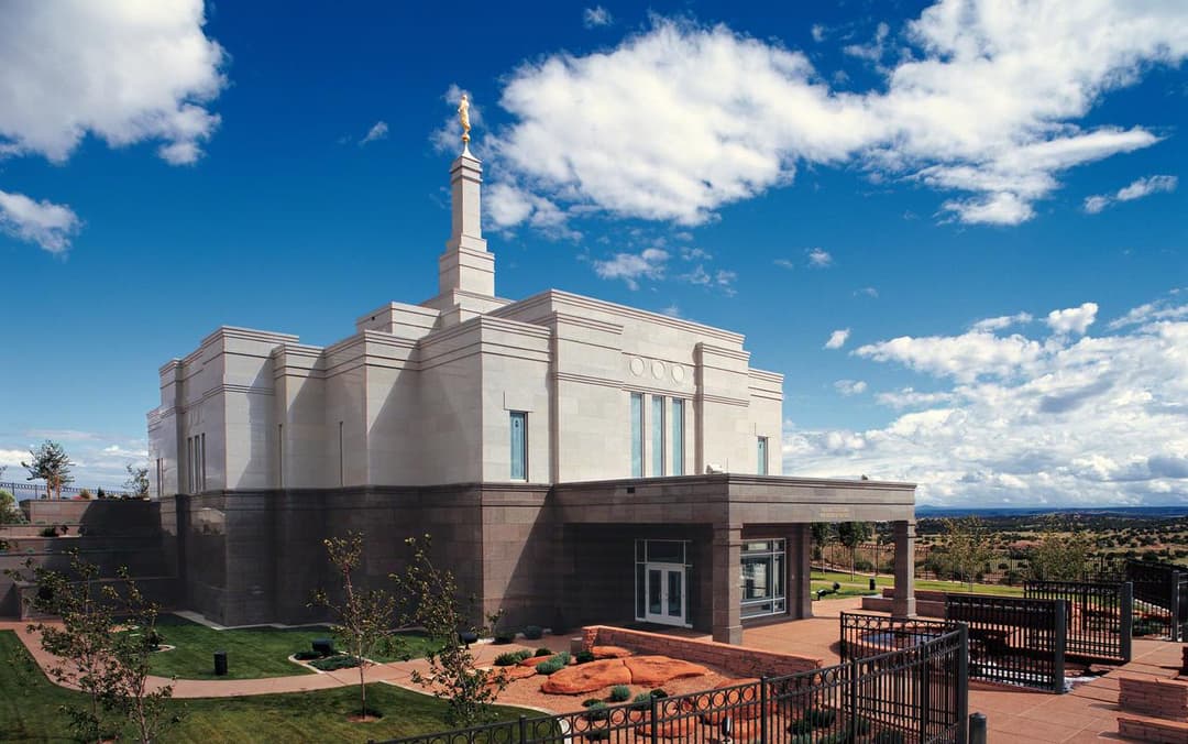 Exterior view of the Snowflake Arizona Temple and grounds under a blue sky.
