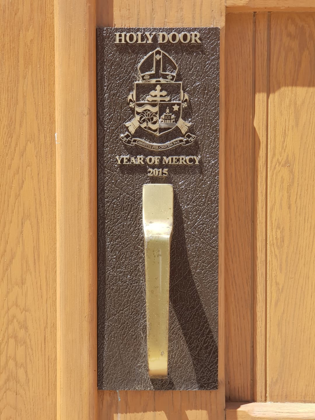 Detail of the Holy Door handle and Year of Mercy 2015 plaque.