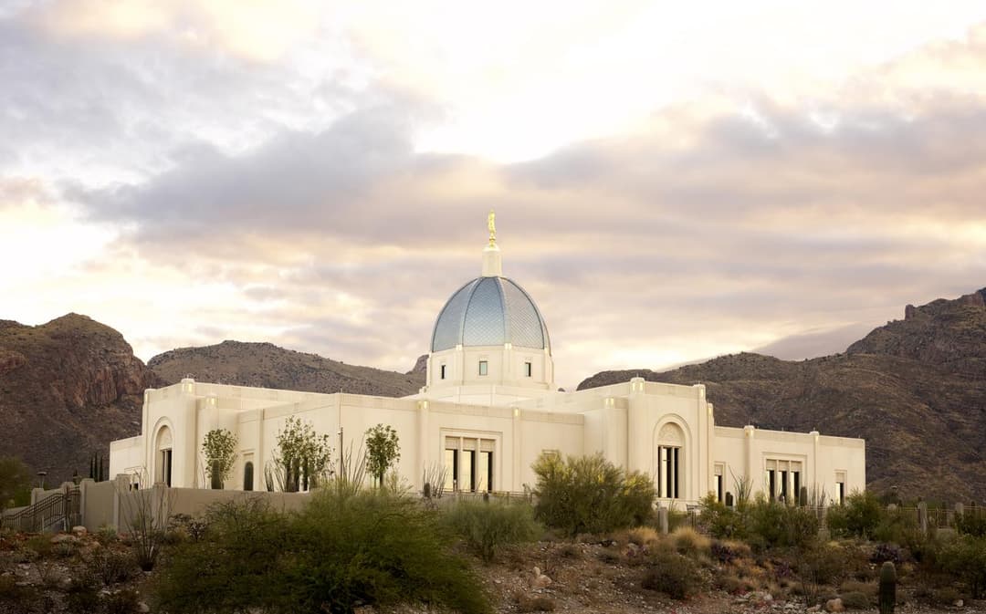 Exterior view of the Tucson Arizona Temple and its blue dome at sunset.