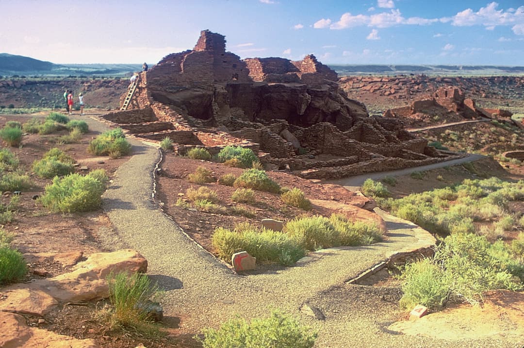 Wide-angle exterior view of Wupatki Pueblo ruins and visitor path.