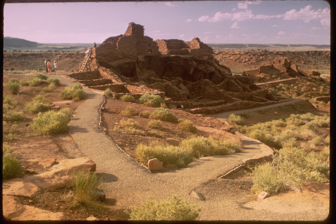 Wide-angle view of the Wupatki Pueblo masonry ruins and surrounding trails.