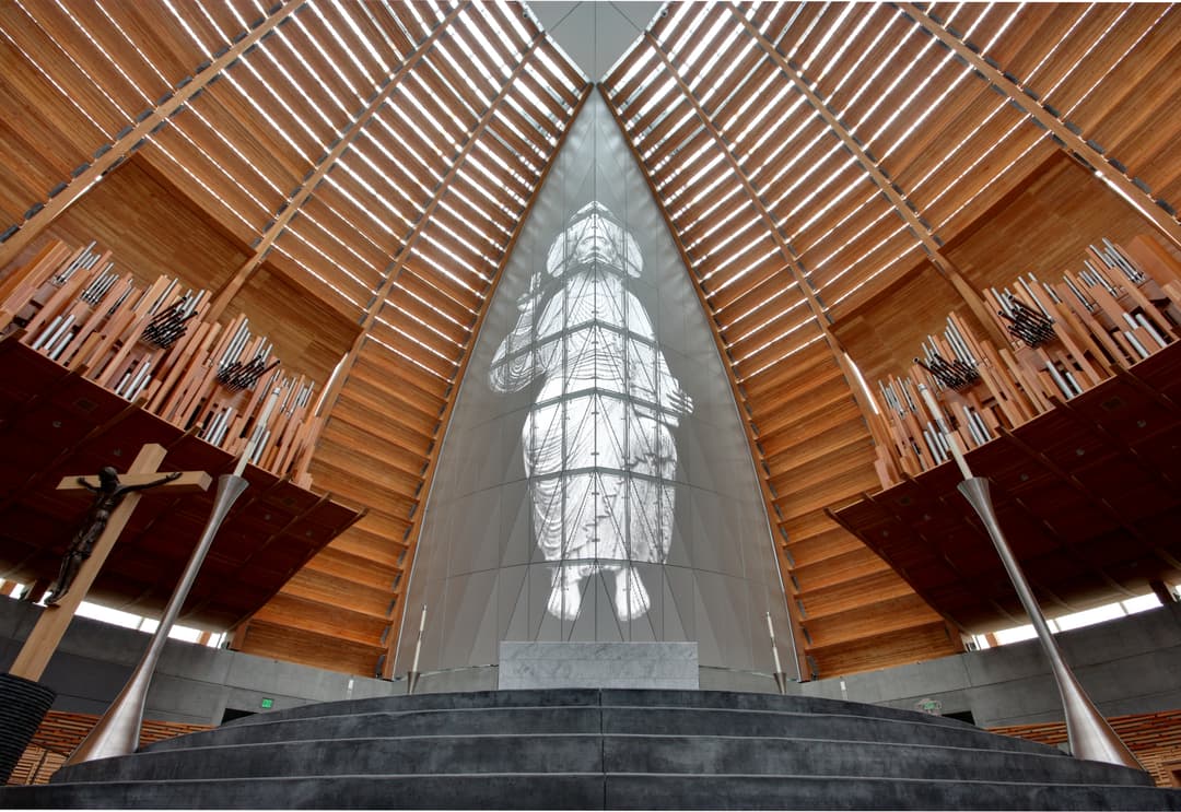 Interior view of the sanctuary featuring the altar and central Christ screen.