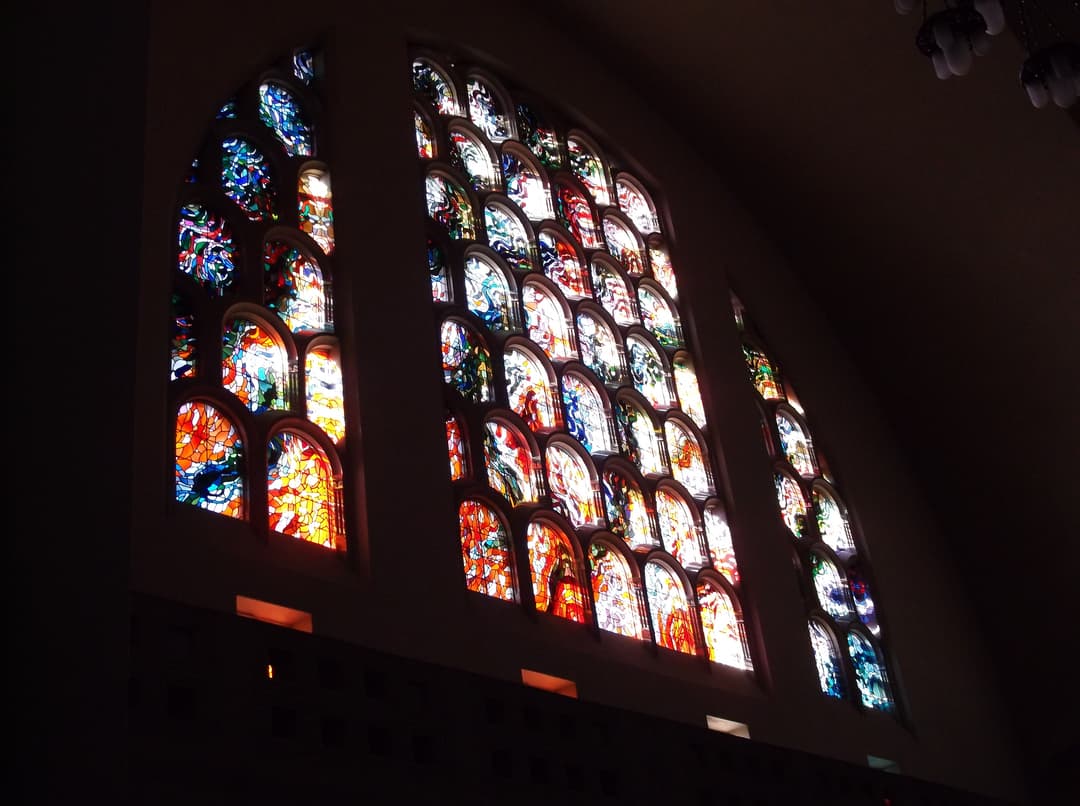 Interior view of the arched stained glass windows in the sanctuary.