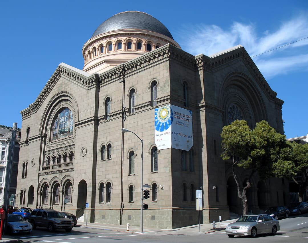Exterior corner view of the stone facade and prominent dome