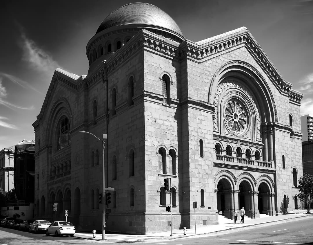 Exterior corner view of the stone facade and monumental dome
