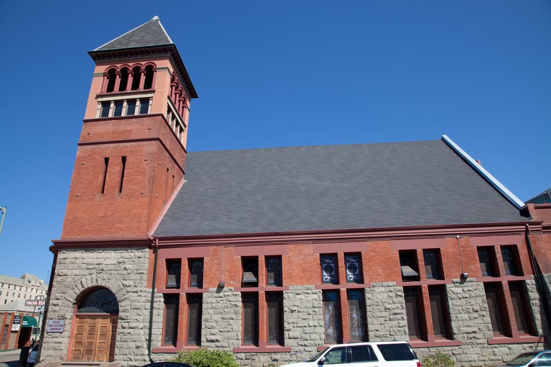 Wide-angle exterior view of the bell tower and facade in daylight.