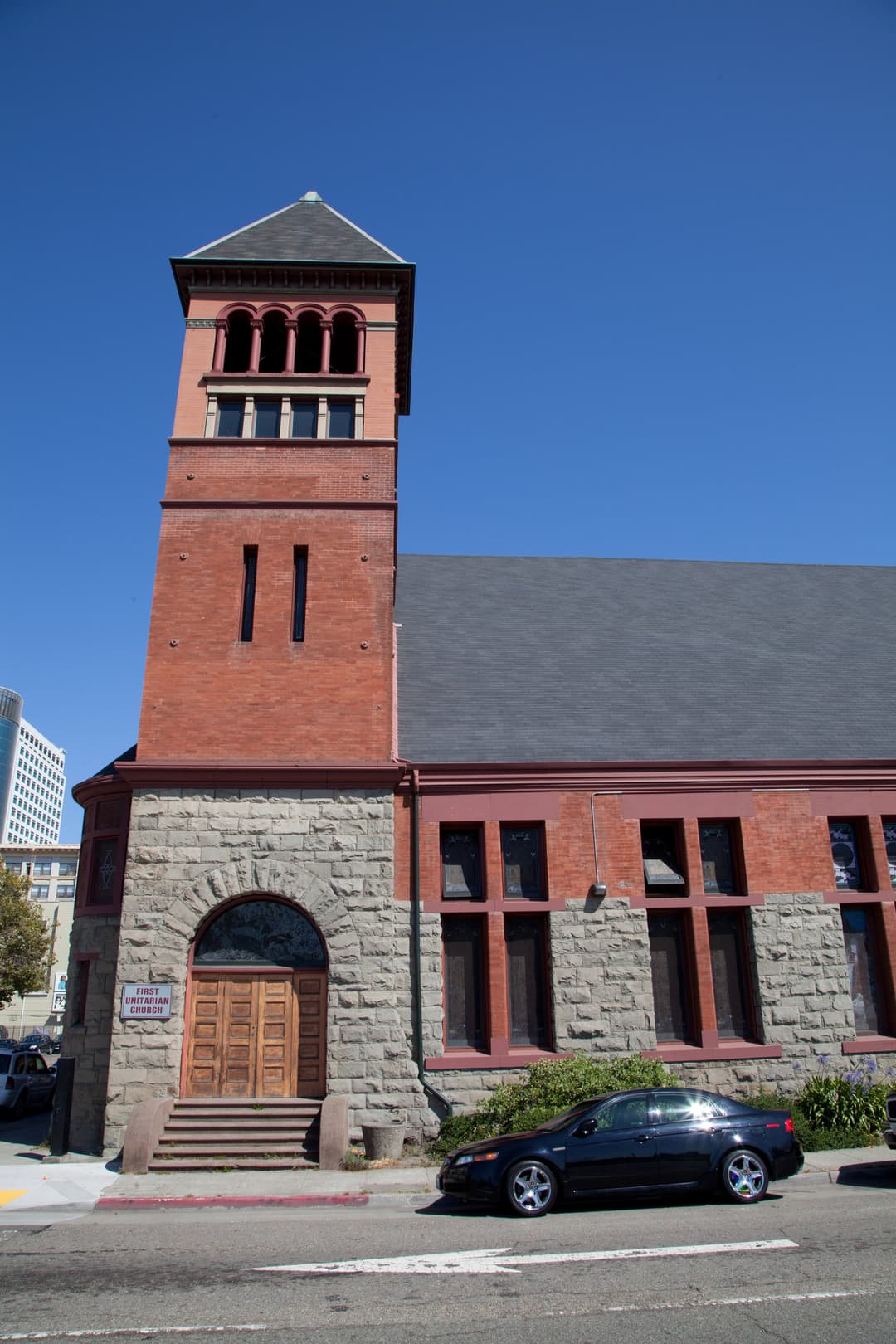 Exterior view of the brick bell tower and arched entrance portal.