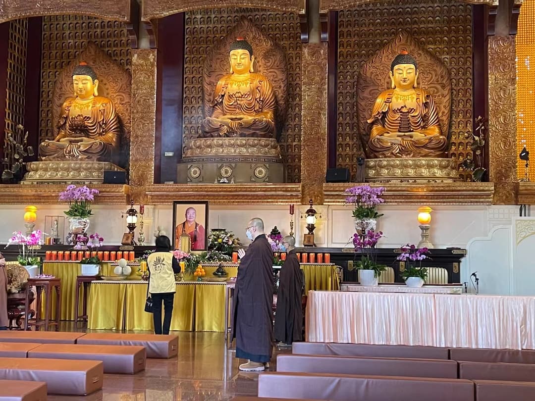 Interior view of the Main Shrine featuring three golden Buddha statues.