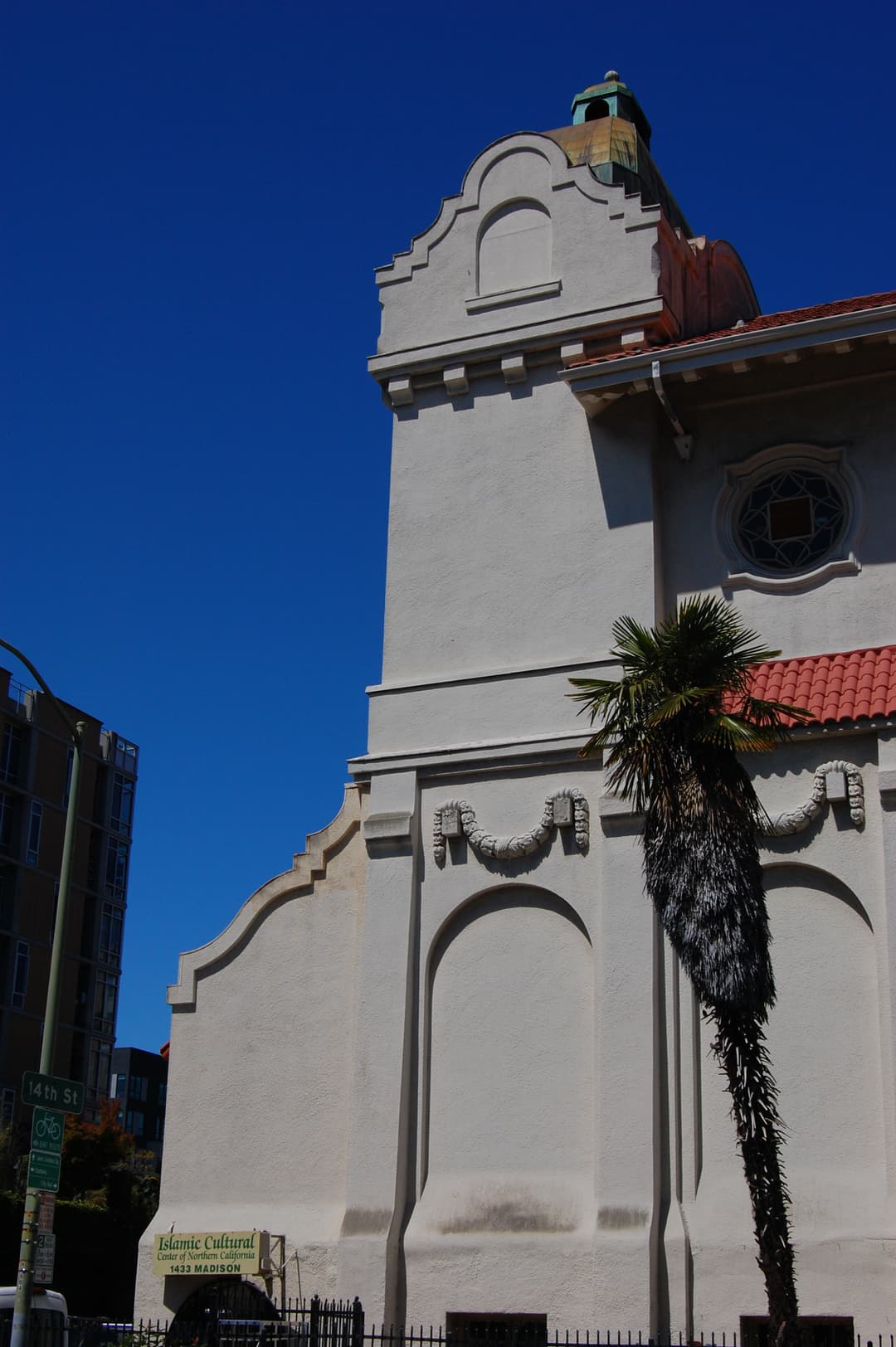 Mission Revival tower and facade detail with palm tree
