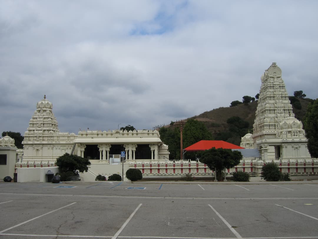 Wide view of the Malibu Hindu Temple complex across the parking lot.