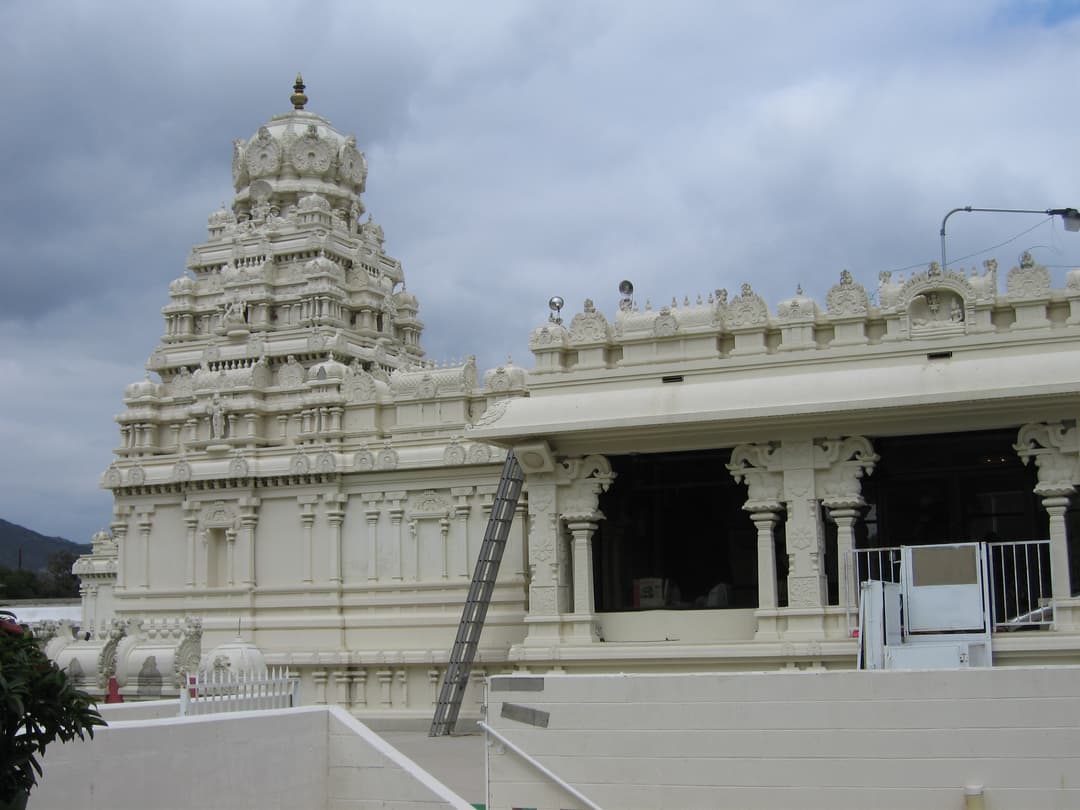 Exterior view of the white vimana tower and pillared mandapa.