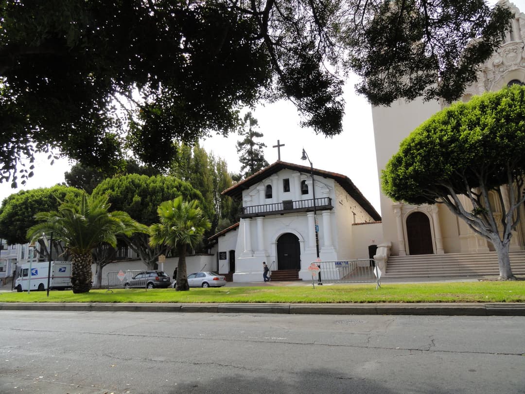 Wide exterior view of the historic Mission Dolores chapel and basilica.