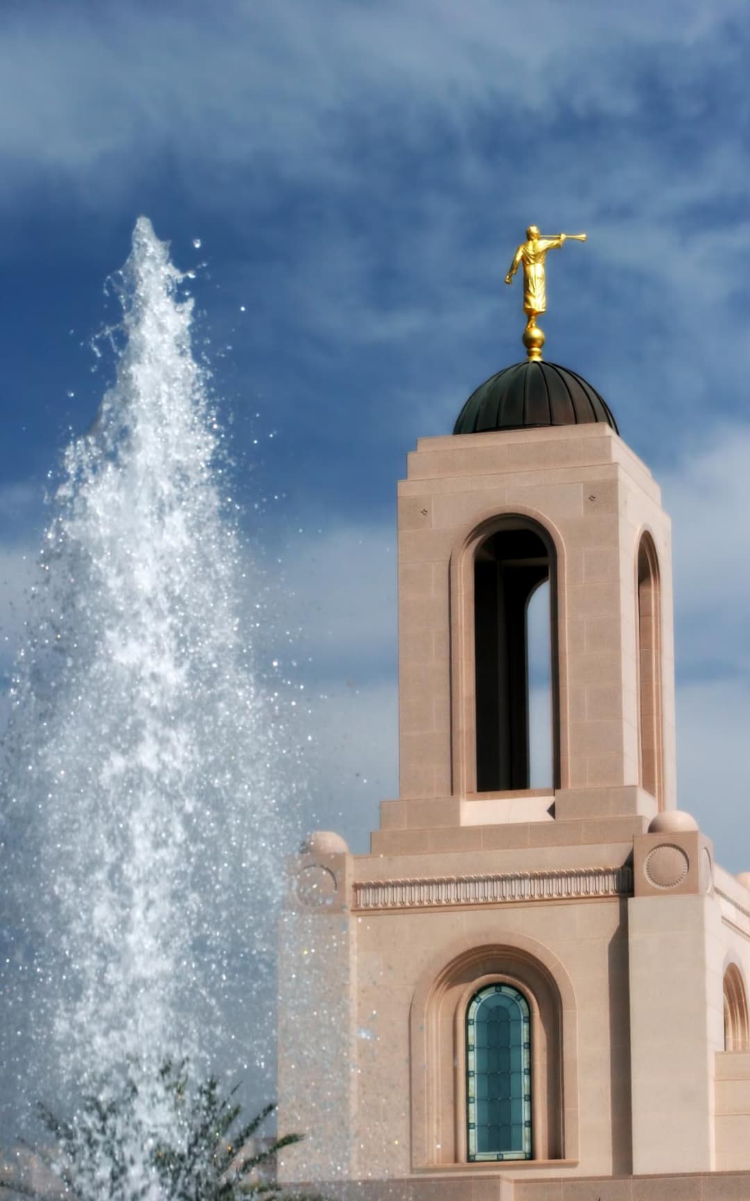 Angel Moroni atop Newport Beach Temple tower with fountain spray.