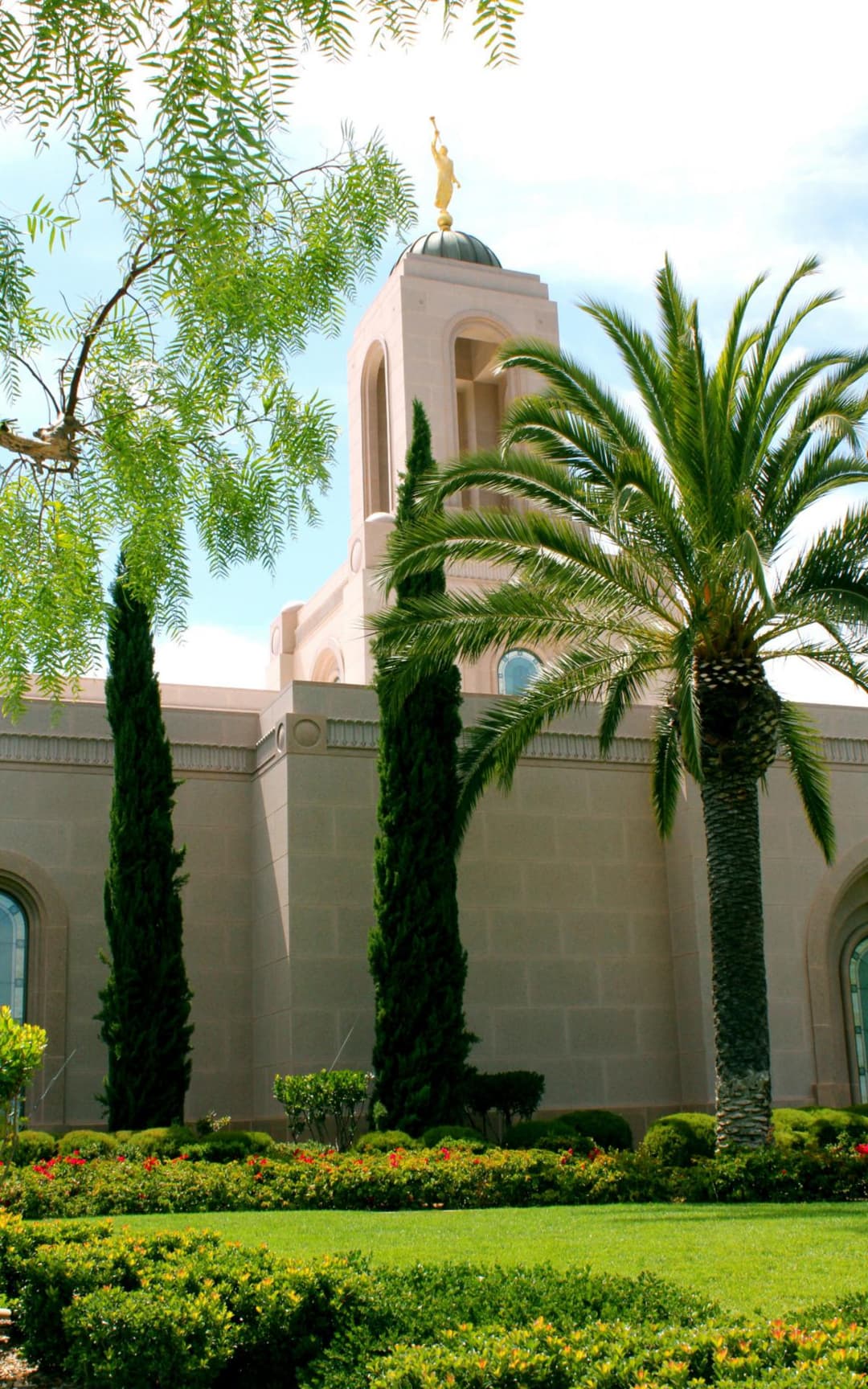 Newport Beach Temple tower with Angel Moroni, dome, and lush grounds.