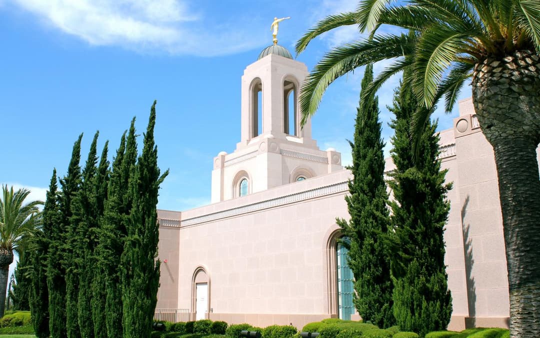 Newport Beach Temple exterior, Angel Moroni, with palm and cypress trees.