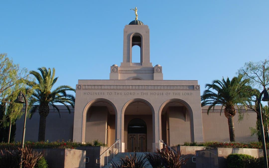 Front exterior of Newport Beach California Temple with Angel Moroni and arches.