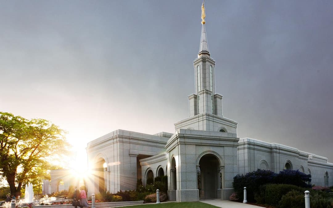 Exterior view of the Sacramento California Temple and spire at sunset.