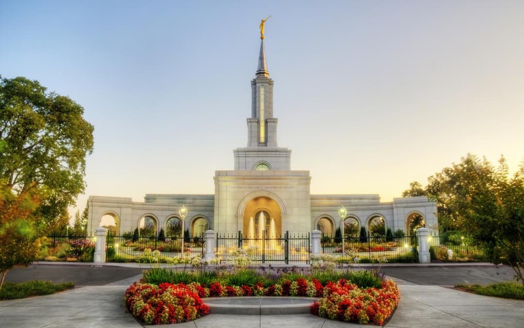 Front view of the Sacramento California Temple and gardens at twilight.
