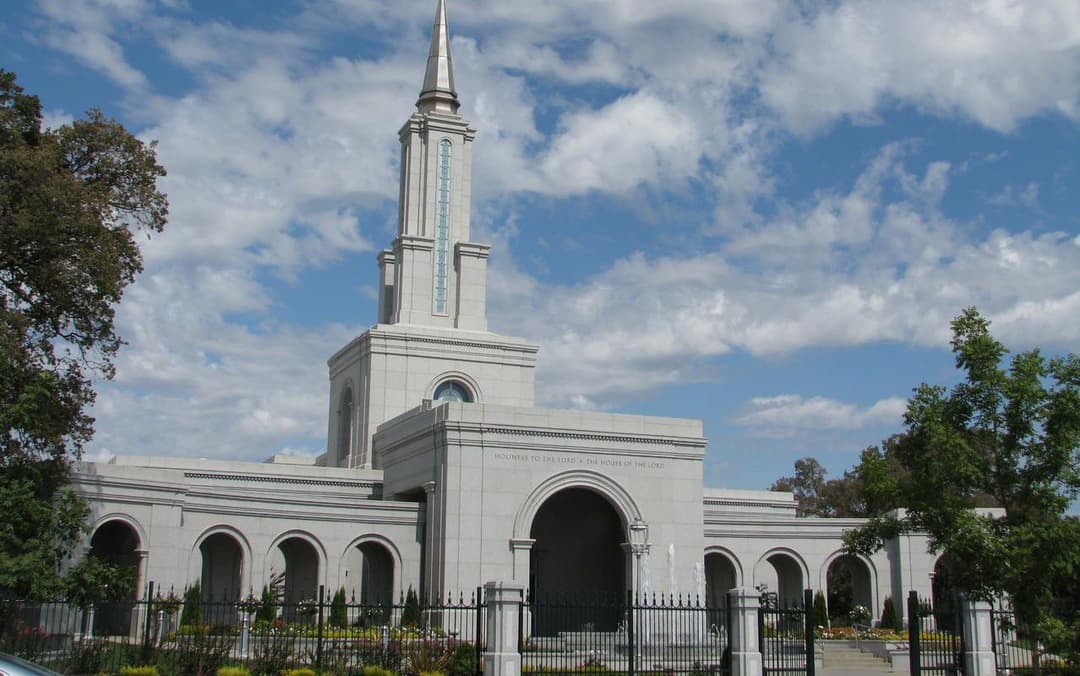 Daytime front view of the Sacramento California Temple facade and spire.