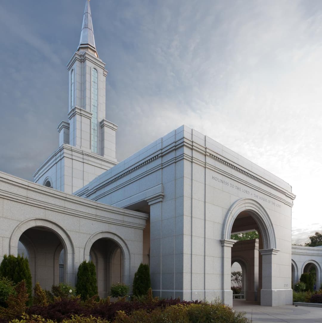 Low-angle view of the Sacramento California Temple entrance and spire.