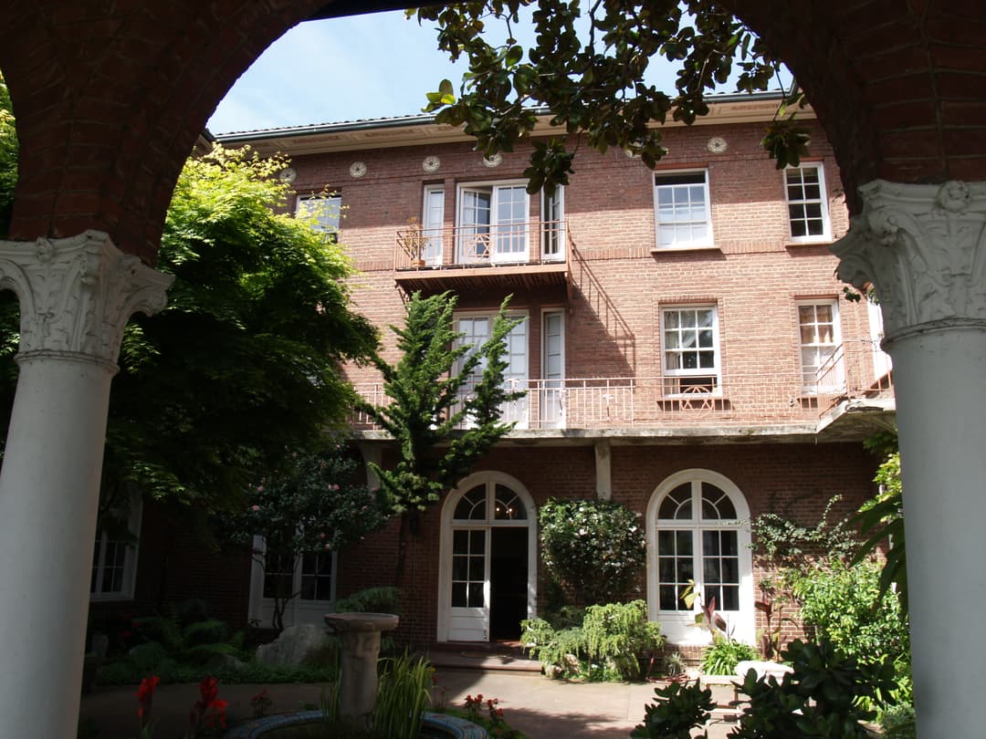 The inner courtyard garden viewed through the ground-floor arcade.